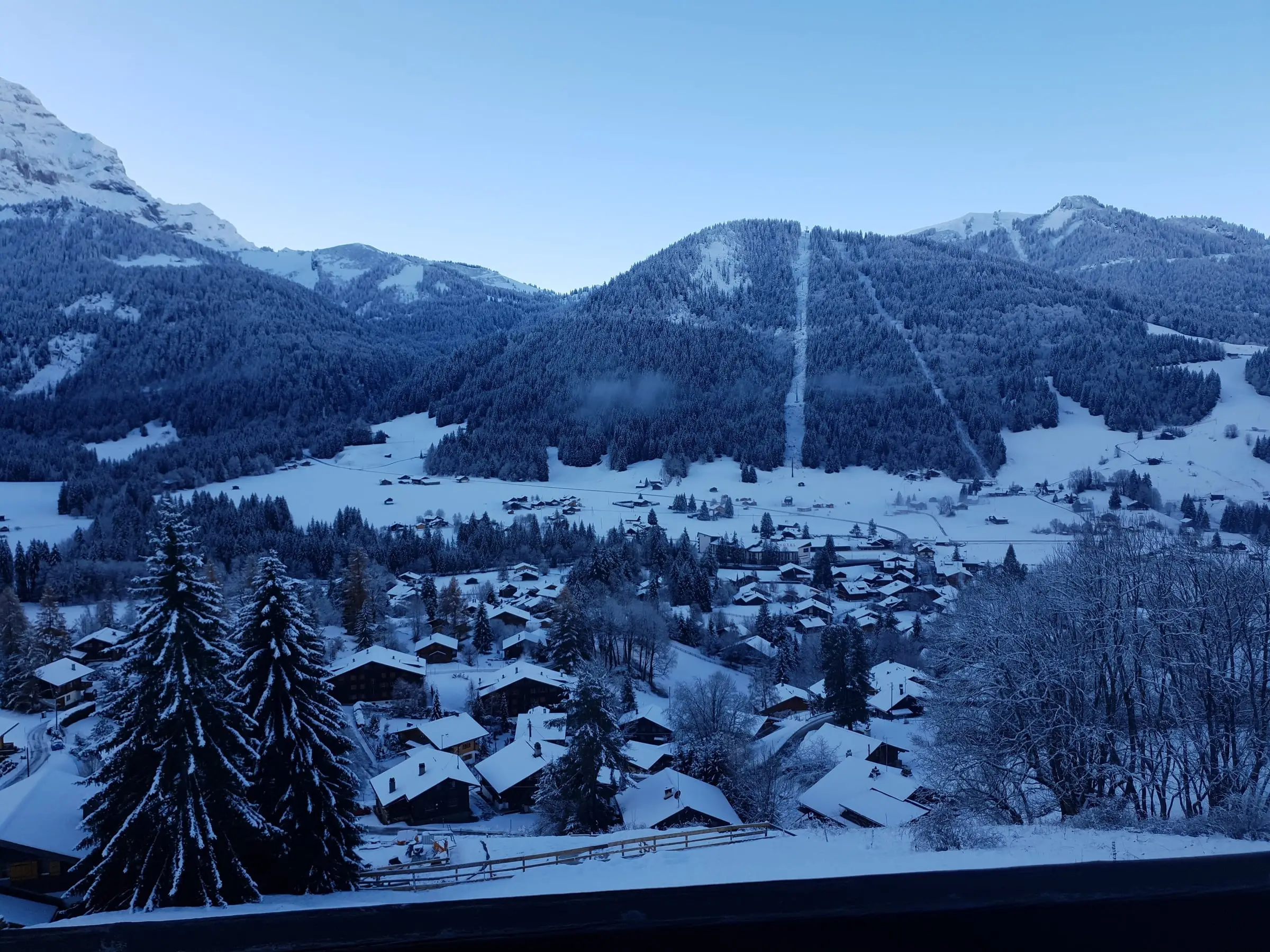 Les Diablerets chalets under fresh snow on a winter morning