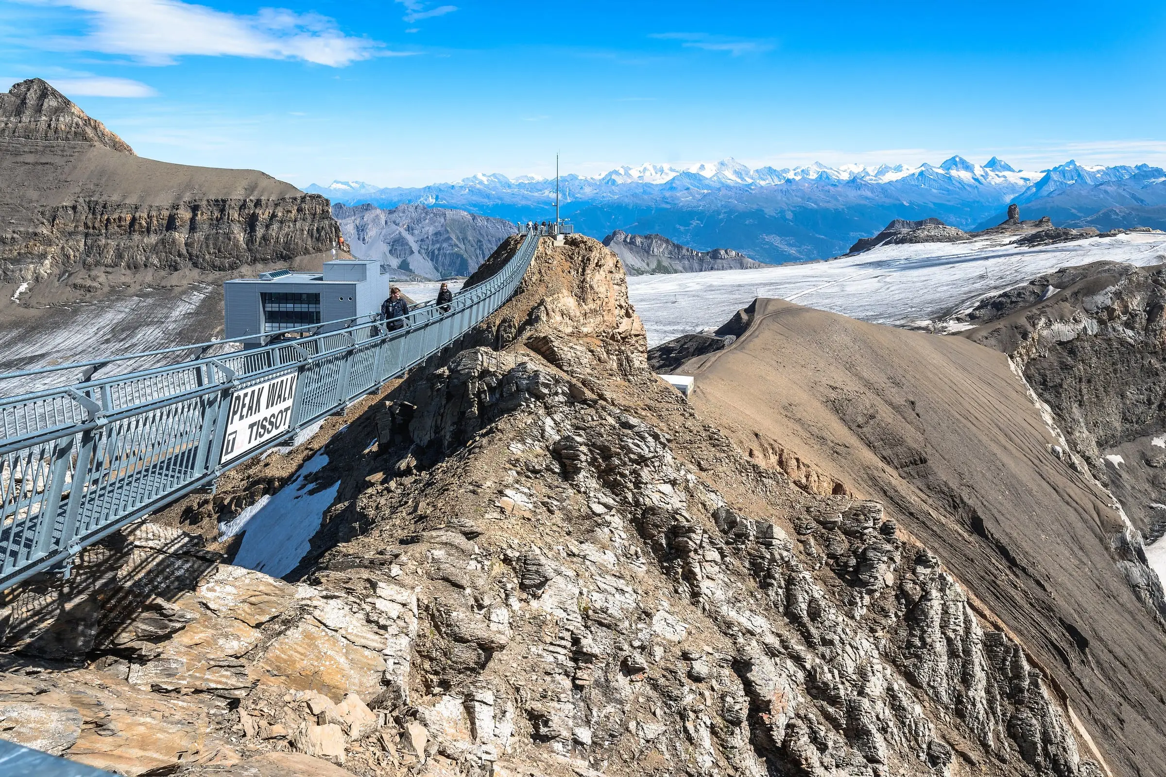 Peak Walk bridge spanning two rocky peaks above the glacier