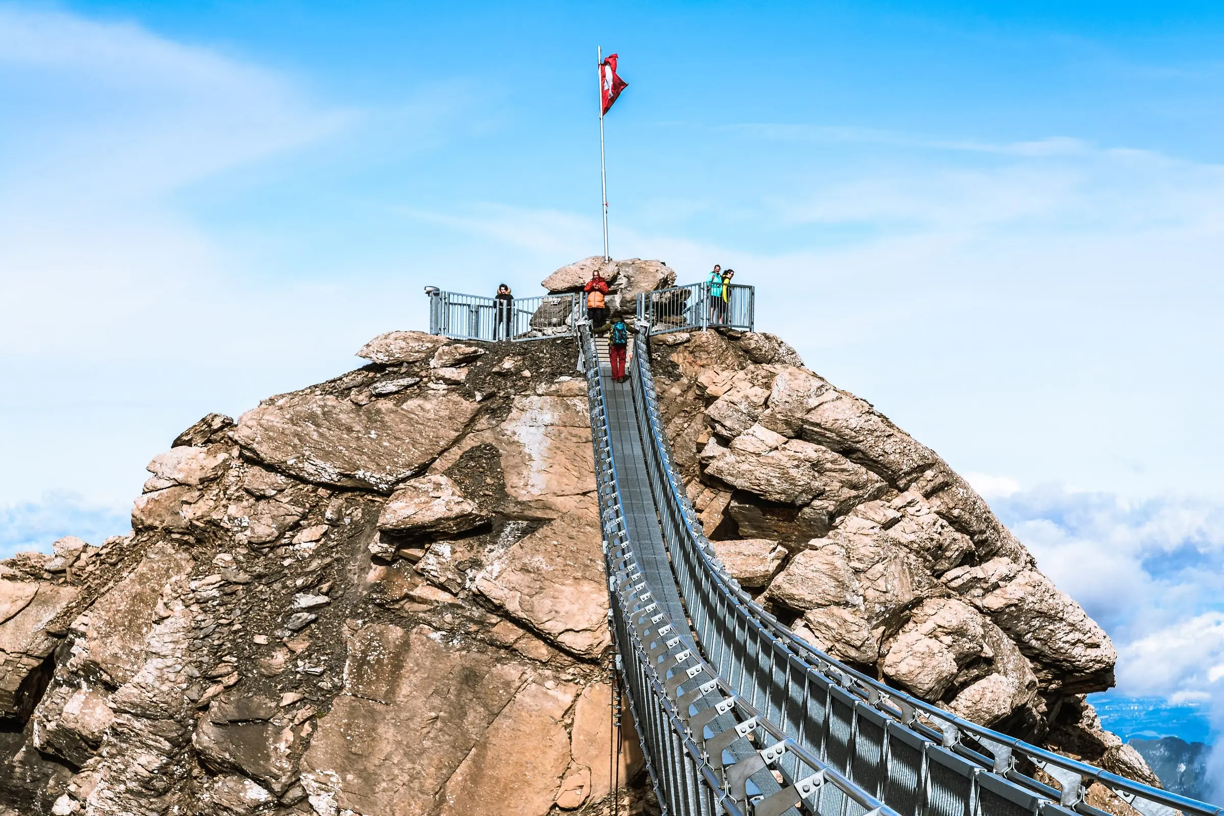 Peak Walk suspension bridge leading to the flagged summit rock