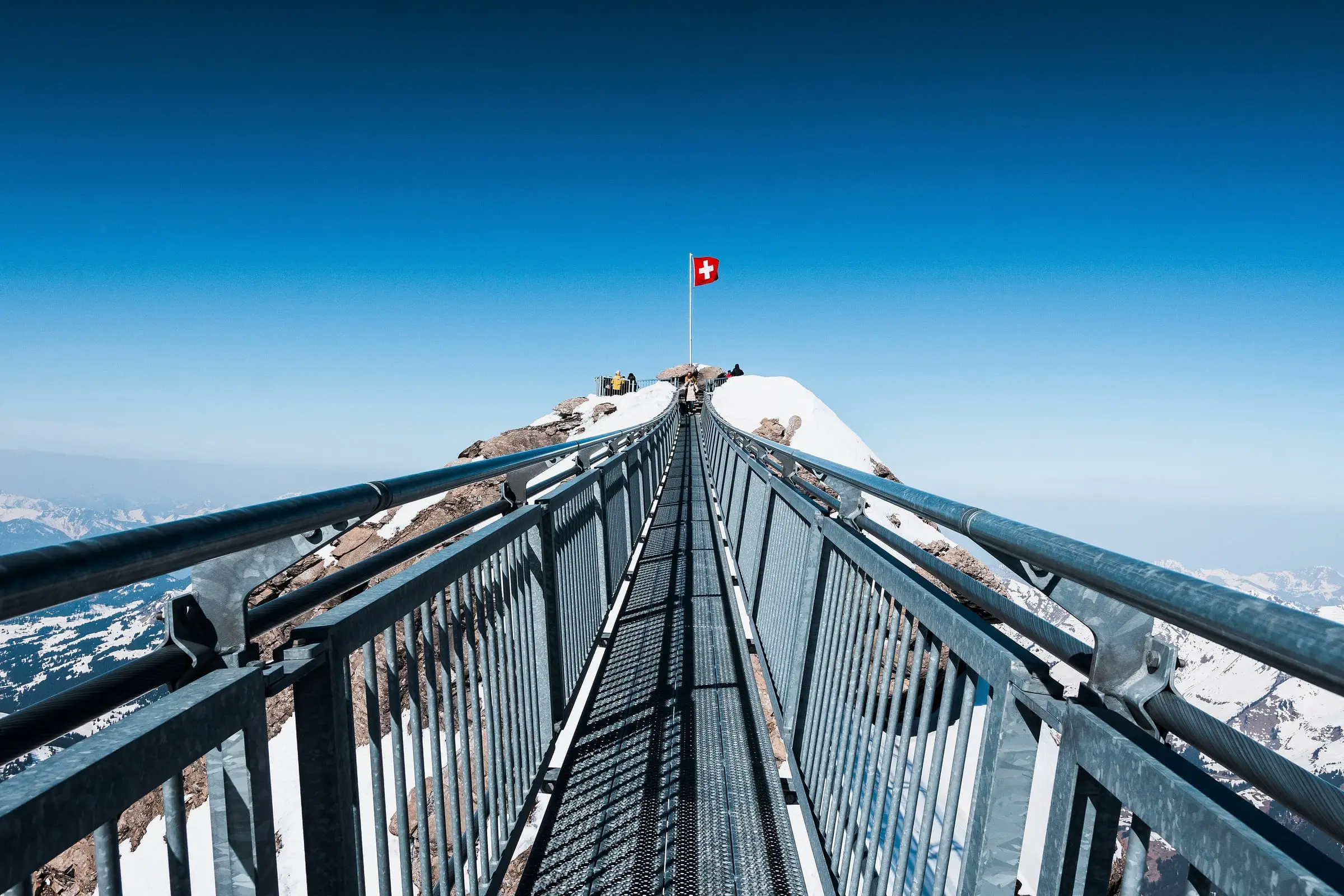 Looking along the Peak Walk bridge to the Swiss flag