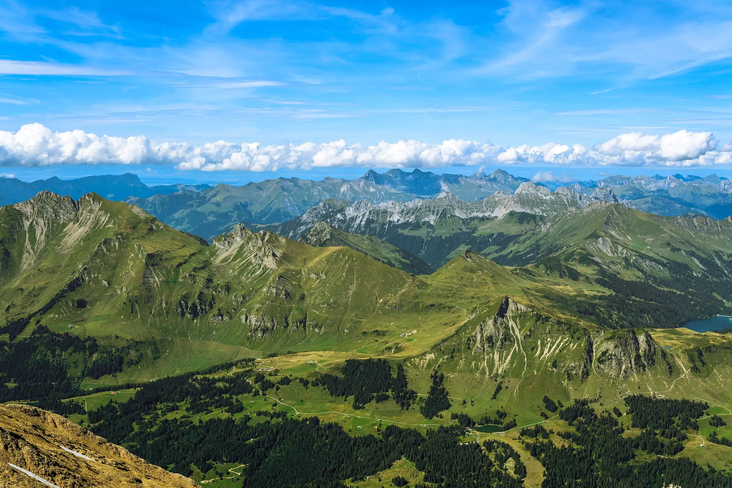 Green Pre-Alps ridges rolling towards distant clouds